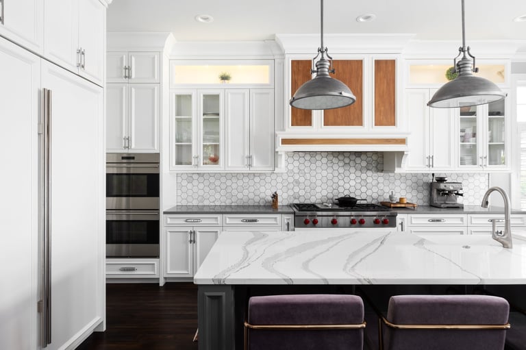 Kitchen with marble island and pendant lights