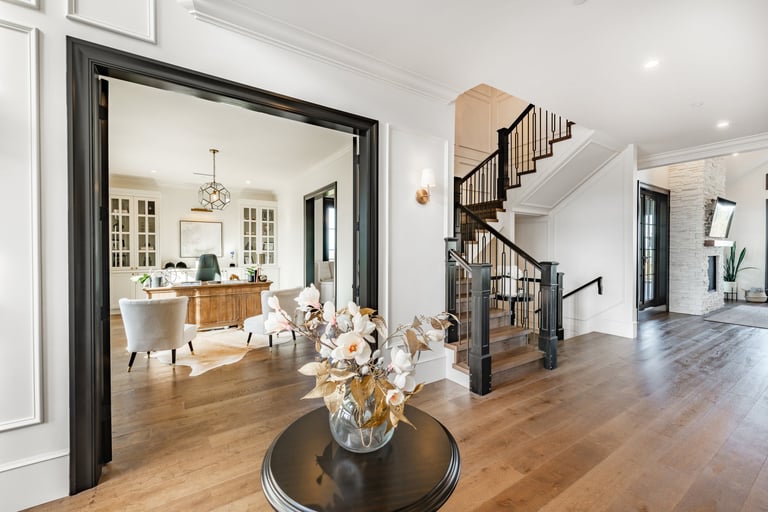 Modern home entry hallway with blue velvet sofas