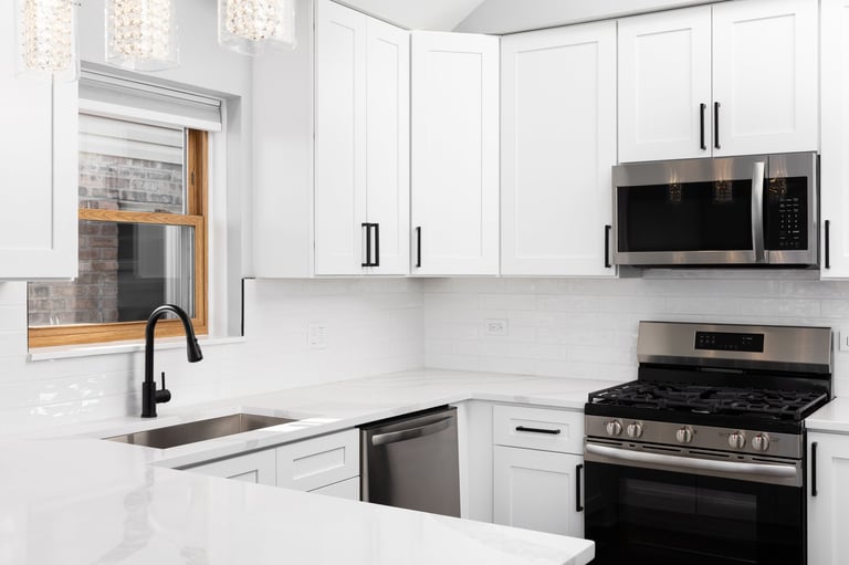 White kitchen with stainless steel and subway tiles